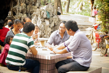 People in the park playing cards and leisure, in Shenzhen, Chinaのeditorial素材