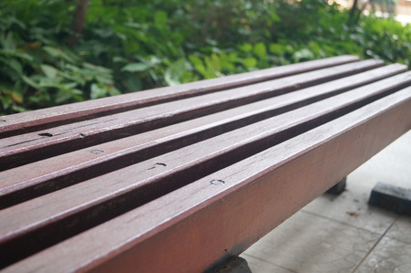 close up to a wooden bench in a park