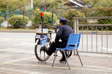 Policeman on duty sitting on a chairのeditorial素材