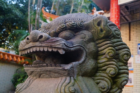 Stone lions at the gate of the park. In Shenzhen, china