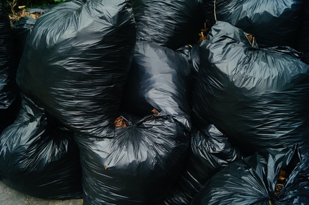 Black plastic bags filled with garbageの写真素材
