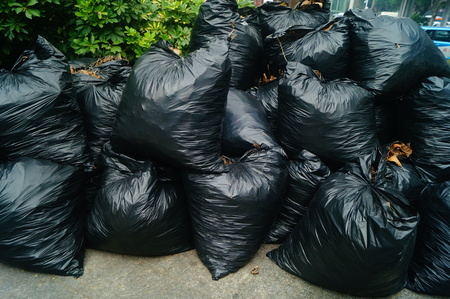 Black plastic bags filled with garbageの写真素材