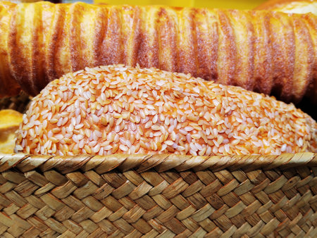 Variety of breads with sesame seeds in wicker basketの写真素材