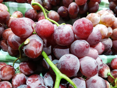 bunch of fresh red grapes in the market, closeup of photoの写真素材