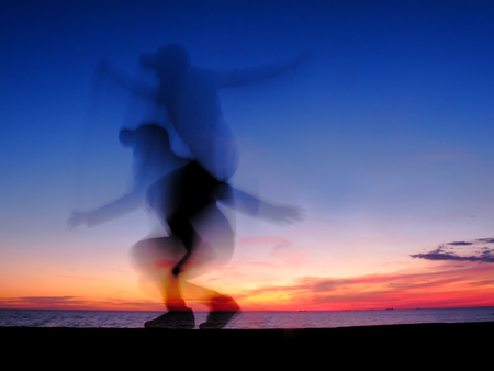 silhouette woman moving body at sea , sunset light