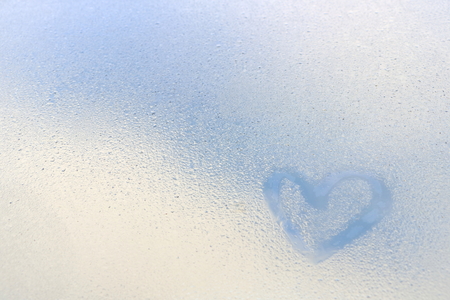 Heart shape draw on water dew on mirror, blue and white tone have copy space for put text, Love concept for valentine dayの写真素材