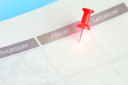 red pin lace on friday of calendar in notebookの写真素材