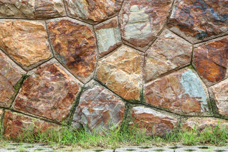 Textured of surface stone wall for background. Tone orange, brown and red color same rust. Have...