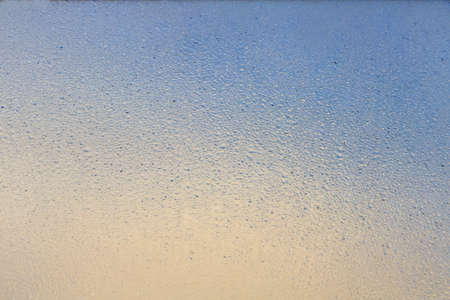 texture of many droplets on mirror orange and blue tone color like sunset or sunrise  for background
