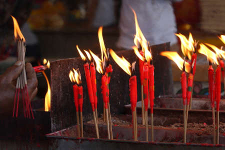 group of burning red chinese candle in templeの写真素材