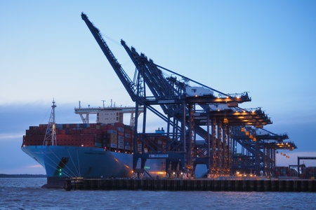 Port of Felixstowe, Suffolk, UK, March 10 2019: Cranes loading containers onto the Marseille Maersk...