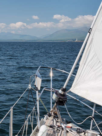 On a sailing yacht approaching Lismore lighthouse on Eilean Musdile in the Firth of Lorne at the...