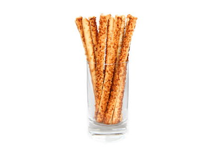 pretzel sticks in a glass on white 