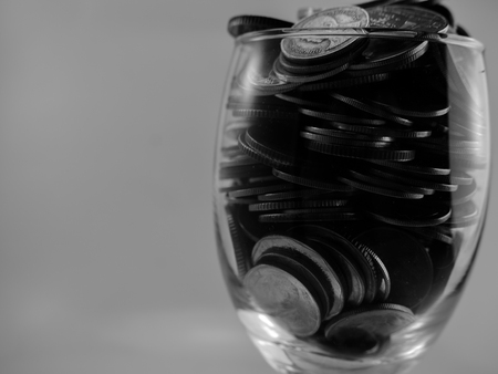 coin in wine glasses black and white toneの写真素材