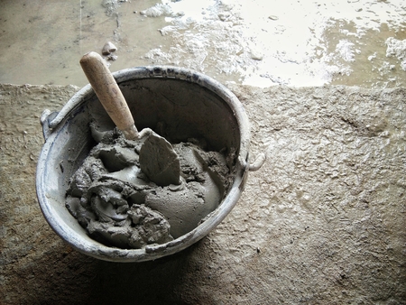 plaster bucket near unfinish plaster wall,with copy space insideの写真素材