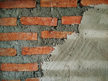 texture of plaster surface on red brick wall in house building ,plasterer craftmanshift construction siteの写真素材