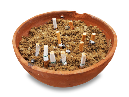 Cigarettes in  ashtray Pottery Cup on isolate with clipping pathの写真素材