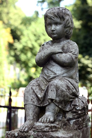 Old statue boy on grave in the Lychakivskyj cemetery of Lviv, Ukraine.の写真素材