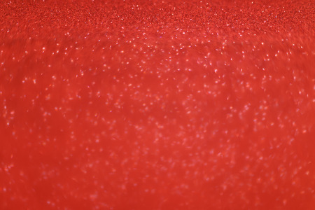 Red glitter background. Christmas beautiful glowing texture