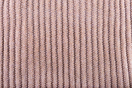 Brown knitted fabric made of heathered yarn textured background