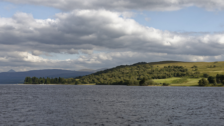 Loch Rannoch, west end, view east to south bank, Perth & Kinross, Scotland 
Schiehallion peak on far leftの写真素材
