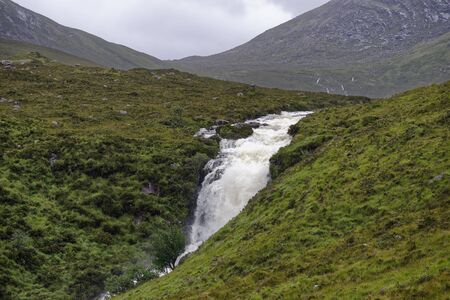 Eas a Bhradain Waterfall on Allt Coire nam Bruadaran river in spate after heavy rain Loch Ainort, Isle of Skye, Western Isles, Scotlandの写真素材
