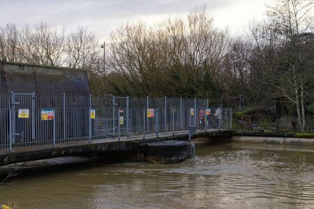 High water levels in River Avon at the Radial Gate and Weir, Chippenham, Wiltshire, UK
