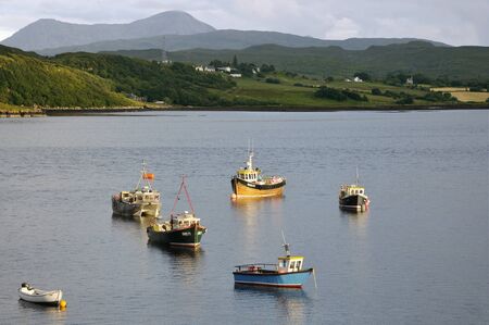 Boats on Loch Portree, Isle of Skye Glamaig Mountains in the distance, Sgurr Mhairi (775M) & An...