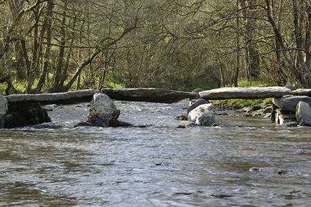 Tarr Steps Clapper Bridge over River Barle near WithypoolViewed from the northの写真素材