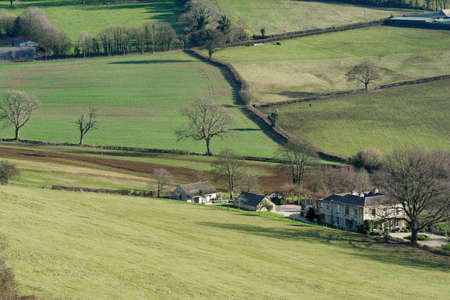 Manor house below Cam Long Down, Gloucestershireの写真素材