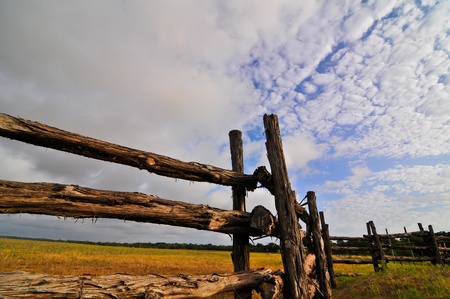 wooden country fence against a vibrant blue skyの写真素材