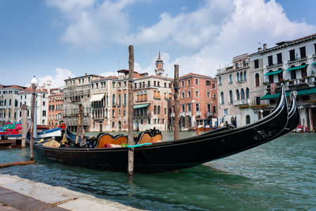 A traditional Gondola moored on the side of the Grand Canal in Veniceのeditorial素材
