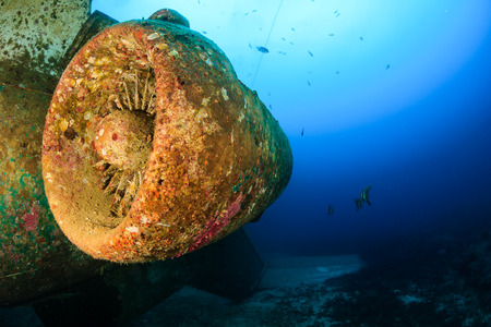The rusting remains of a jet engine and aircraft deep underwaterの写真素材