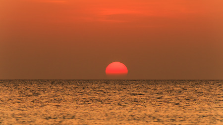 Tropical sunset over a calm oceanの写真素材
