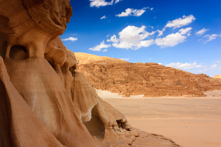 Rock formations in an empty, sandy desertの写真素材
