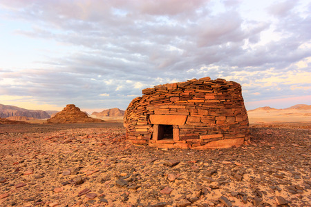 Ancient tombs in the desert glow orange in the late evening sunの写真素材