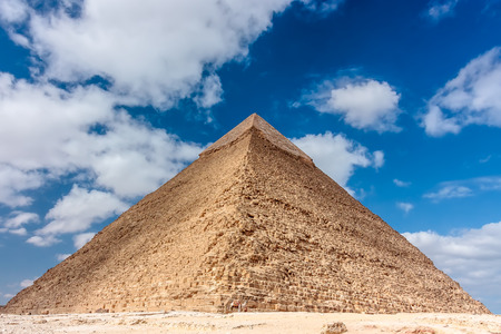 The pyramid of Khafre with the original stone cladding on its apex and a camel in frontの写真素材
