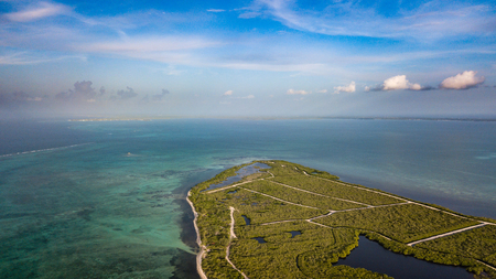 A remote mangrove forest leading onto a large, tropical, coral lagoonの写真素材