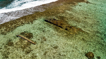 Shipwrecks in clear, shallow water on a tropical coral reefの写真素材
