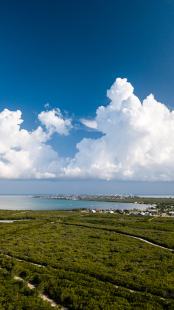 Storm clouds forming over a green, tropical islandの写真素材