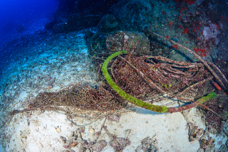 Abandoned fishing equipment polluting a tropical coral reefの写真素材