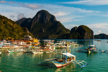 Hundreds of traditional wooden Banca boats wait at a port in El Nido, Palawanのeditorial素材