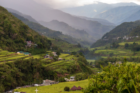 Rice terraces and background cloud and rain over the surrounding mountainsの写真素材