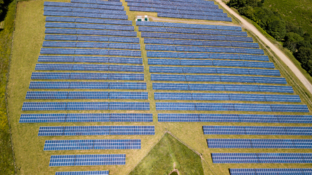 Aerial drone view of a solar energy farm on a mountainside (South Wales)