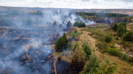 Aerial drone view of a smouldering wildfire in Wales, UKの写真素材