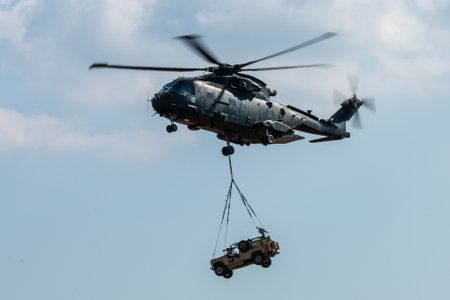 RNAS YEOVILTON, ENGLAND - July 07, 2018: A Royal Navy Merlin HC3 helicopter with an underslung...