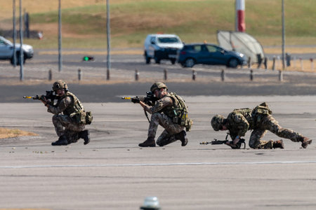 RNAS YEOVILTON, ENGLAND - July 07, 2018: Armoured vehicles and commandos performing at the Yeovilton International Air Day as part of the Helicopter Force Role Demo at RNAS Yeovilton, Englandのeditorial素材