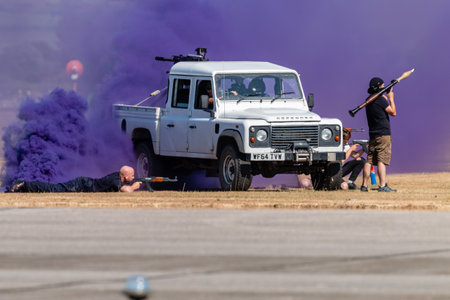 RNAS YEOVILTON, ENGLAND - July 07, 2018: Armoured vehicles and commandos performing at the Yeovilton International Air Day as part of the Helicopter Force Role Demo at RNAS Yeovilton, Englandのeditorial素材