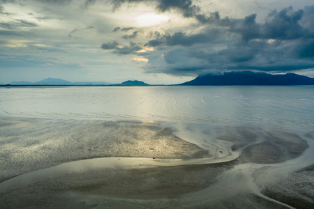 Aerial view of sunset and clouds over the ocean at low tide in Sarawak, Malaysian Borneoの写真素材