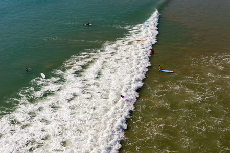 Aerial view of surfers in shallow water in Khao Lak, Thailand